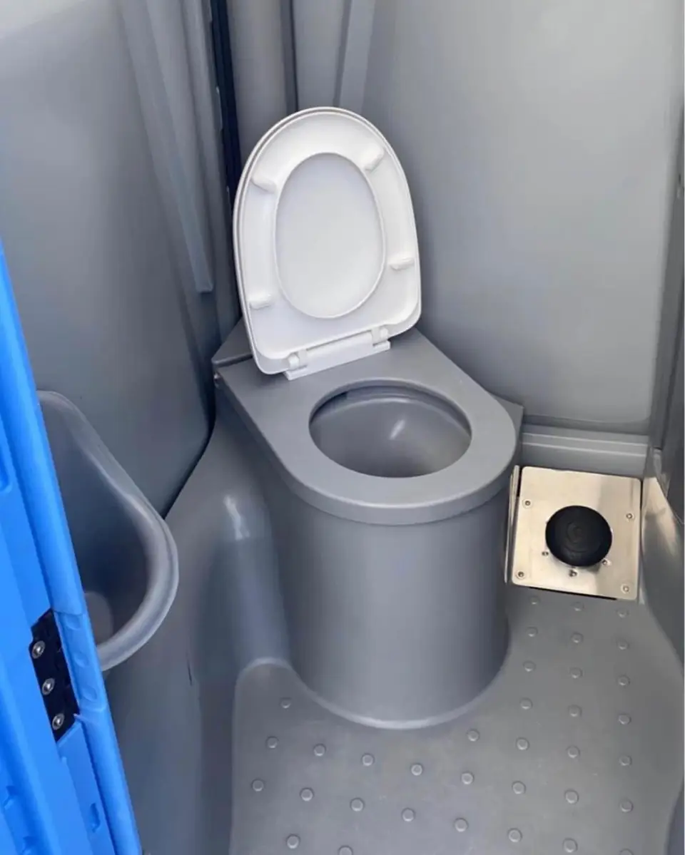Close view of a clean porta potty toilet seat and lid