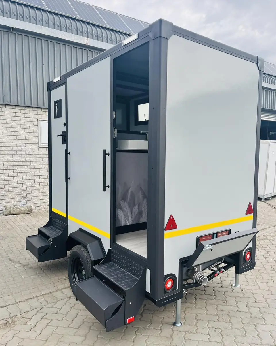 Restroom trailer exterior with steps and wheel fenders