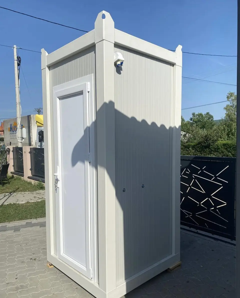White single-room VIP flushing restroom cabin on a paved lot